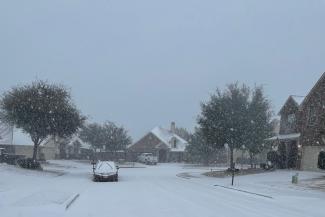 Snow falls in a neighborhood in Roanoke, TX in Feb 2021